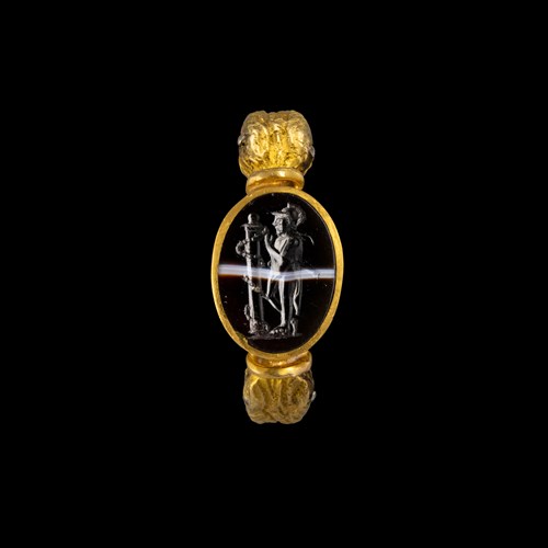 An Italic banded agate intaglio set in a gold ring. Warrior consulting an oracle.